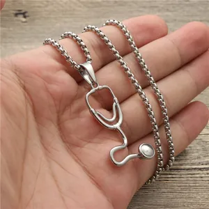 Silver stethoscope pendant necklace with bead chain shown on a wooden background