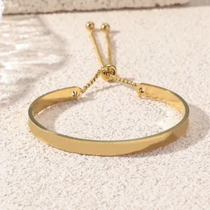 Adjustable gold stainless steel bangle bracelet with drawstring chain and polished finish