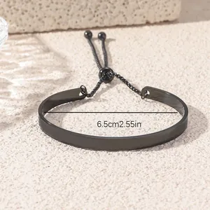 Adjustable black stainless steel cuff bracelet with pull-chain and 6.5cm diameter bar