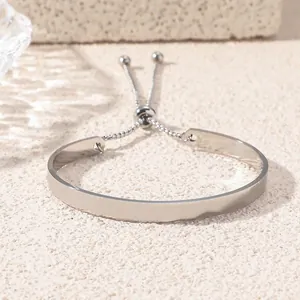 Polished silver stainless steel Ayatul Kursi bracelet on a textured stone base