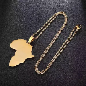 Macro detail of gold African map pendant with mirror finish on black leather texture
