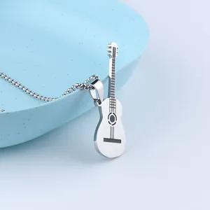 Detailed macro view of a silver guitar pendant on a box chain over a blue tray