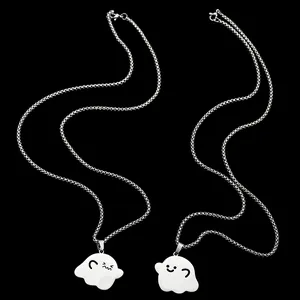 Close-up of dual silver cartoon ghost pendants on sleek stainless steel chains