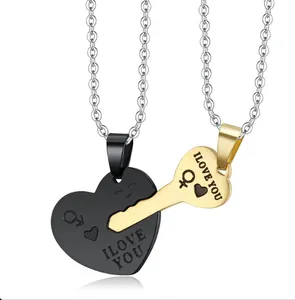Detail of stainless steel couple necklaces featuring black heart lock and gold key pendants