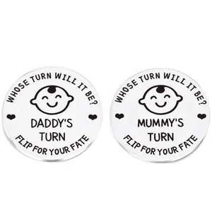 Detailed macro of stainless steel decision coins for parents with Daddy and Mummy turn engraving