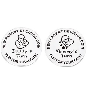 Macro detail of stainless steel New Parent Decision Coins with Daddy and Mummy engraving