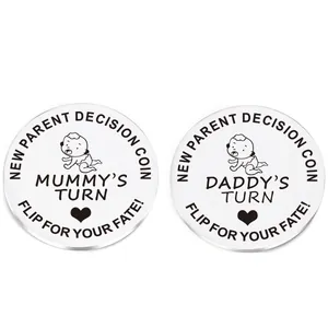 Detailed views of stainless steel new parent decision coin with engraved Mummy and Daddy turns