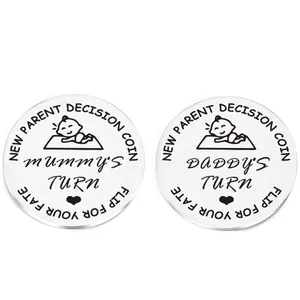 Detail of baby decision coin for parents showing Mummy's Turn and Daddy's Turn text