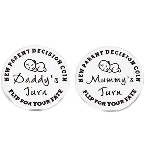 Detailed macro view of polished stainless steel decision coin for new parents with engravings