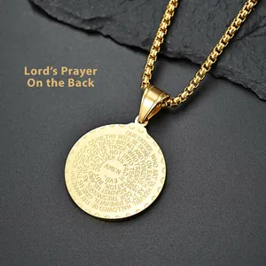 Macro detail of the Lord's Prayer engraving on a golden stainless steel round pendant