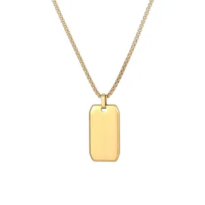 Detailed macro view of a polished gold rectangular dog tag pendant on a round box chain