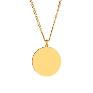 Macro shot of mirror-finish gold stainless steel round disc pendant and curb chain