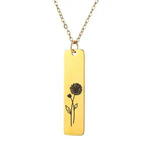 Close-up of golden stainless steel necklace with rectangular floral engraved bar pendant