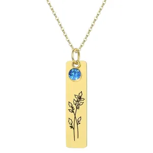 Gold rectangular pendant necklace with blue gemstone and floral engraving on thin chain