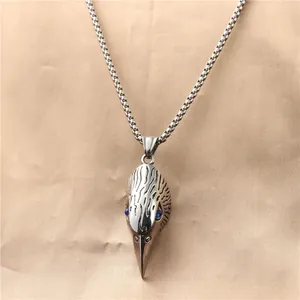 Macro detail of gothic eagle head pendant with blue gems and carved feather texture