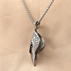Macro view of vintage eagle pendant showing detailed metallic texture and engraving
