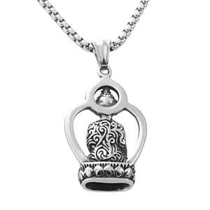 Detailed close-up of a retro stainless steel Buddha pendant with vintage relief carving