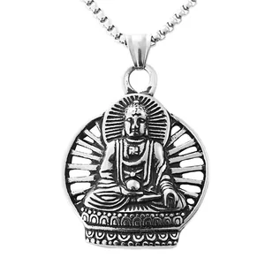 Macro detail of vintage silver buddha pendant showing relief carving and box chain