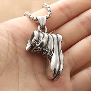 Retro stainless steel work boot pendant on box chain held for size reference
