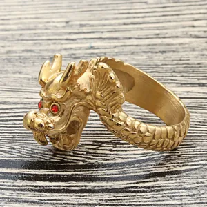 Vintage punk dragon head ring in gold steel with red gemstone eyes and scale textures