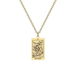 Détail du collier doré avec pendentif carte de tarot Le Fou sur une chaîne en O