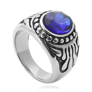 Close-up of a vintage steel ring featuring a blue faceted stone and gothic carvings