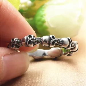 Vintage gothic skull ring in oxidized titanium steel with detailed punk carvings