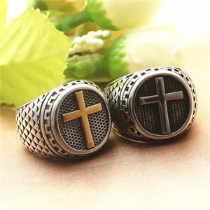 Close-up of vintage titanium steel rings with cross motifs and honeycomb textures