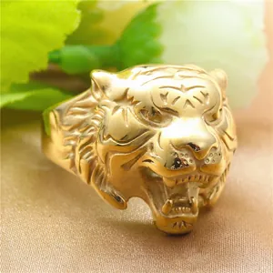Macro view of gold tiger head ring with detailed engraving of roaring facial features