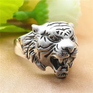 Detailed close-up of a vintage steel tiger ring with lifelike roaring feline facial details