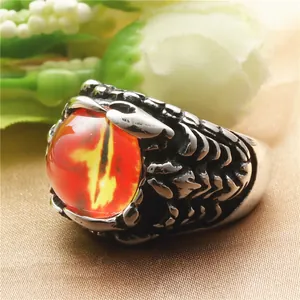 Detailed close-up of punk dragon claw ring featuring a red dragon eye and scale texture