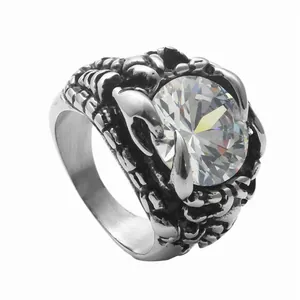 Macro shot of silver stainless steel dragon claw ring with large round clear gemstone