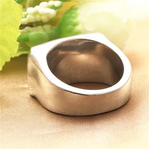 Vintage punk silver stainless steel wide skull ring for men on golden silk background