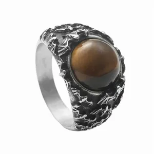 Detail view of a vintage titanium steel ring featuring a round brown tiger eye stone