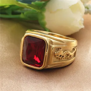 Close-up of vintage gold titanium steel ring with red rectangular stone and dragon carving