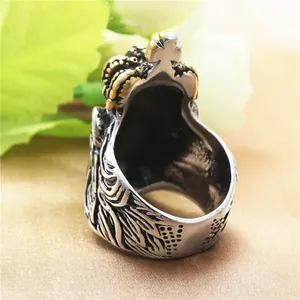 Vintage gothic lion ring with golden crown and steel band on satin background