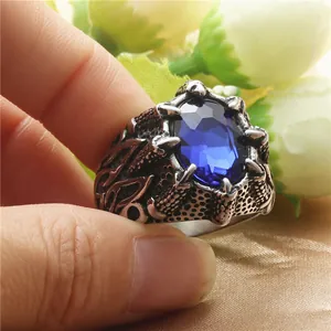 Detailed view of punk dragon claw ring with large oval blue stone in vintage steel