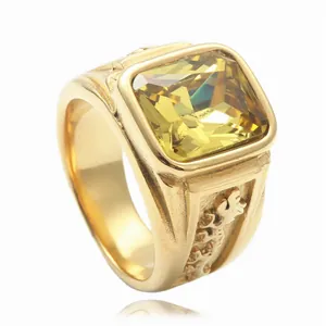 Detailed view of men's vintage gold ring featuring a square yellow gemstone and ornate relief
