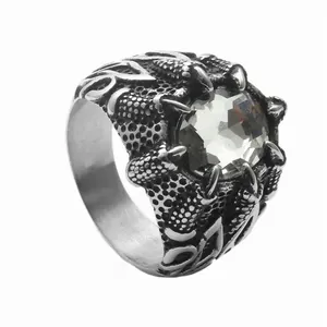 Macro shot of gothic silver dragon claw ring holding a faceted clear crystal stone