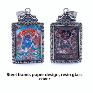 Macro detail of Mahakala and Jambhala pendants in steel frames with ornate patterns