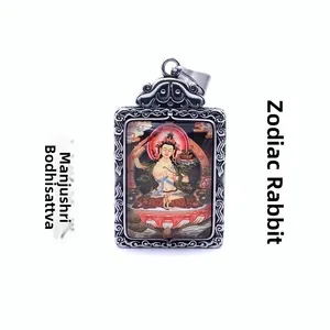 Detail of silver-finish Manjusri Bodhisattva pendant with traditional engraved patterns