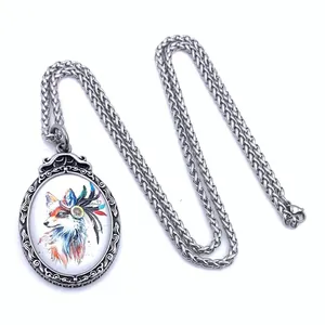 Macro shot of titanium steel pendant with colorful painted fox art and hollow carving