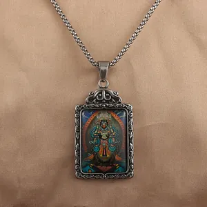 Detailed relief engraving on the vintage titanium steel pendant with colorful thangka art