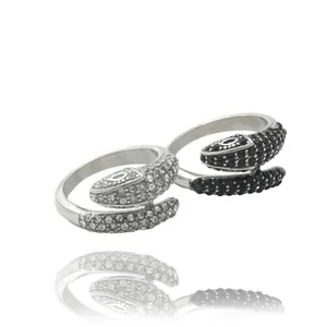 Detailed view of snake rings featuring white and black cubic zirconia stones in silver finish