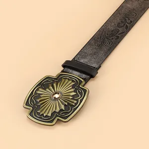 Bohemian embossed leather belt with vintage bronze gemstone buckle in a high-angle view