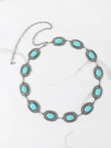 Detailed view of silver alloy waist chain featuring carved patterns and turquoise stones