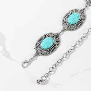 Vintage silver waist chain belt featuring turquoise stones and intricate carved patterns
