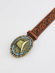 Close-up of western buckle with cowboy hat design and turquoise beads on vintage belt