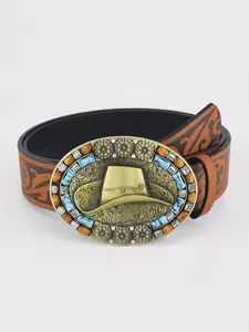 Detail of vintage brown leather belt with embossed patterns and turquoise buckle