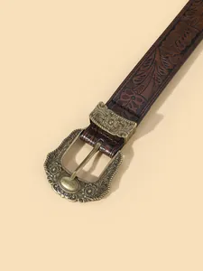 Vintage bohemian brown leather belt with embossed floral patterns and bronze buckle
